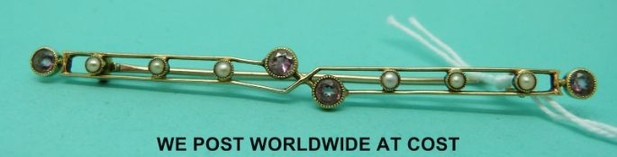 A yellow metal brooch set with seed pearls and topaz