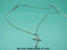 A white metal chain and crucifix marked 375 (3.