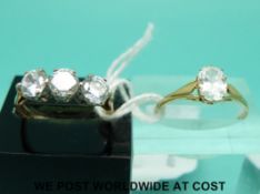 Two 9ct gold rings one with three cubic zirconia (size K) and the other oval cubic zirconia (size