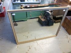 A bevelled glass mirror with ornate frame (H84xW108cm)