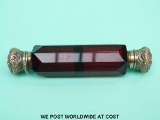 A red cut glass double ended scent bottle with embossed lids (one end is hinged,
