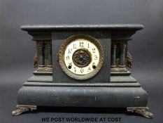 A wooden cased faux slate / marble two-train mantel clock, striking on a gong,