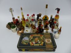A collection of miniatures including a tin containing five bottles of Grants whiskey