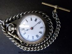 French white metal pocket watch with black Roman numerals and white enamel dial, on graduated chain,