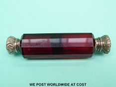 A red cut glass double ended scent bottle with embossed lids (one end is hinged,