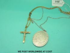 A 9ct gold crucifix on a yellow metal chain,