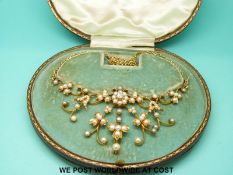 An Edwardian gold articulated necklace set with pearls and a diamond of approximately 0.