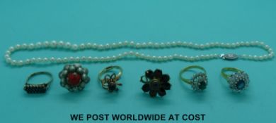 A cultured pearl necklace together with five costume jewellery rings.