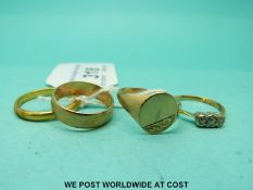 A 22ct gold wedding band (3.4g), a 9ct gold signet ring and a 9ct gold wedding band (4.