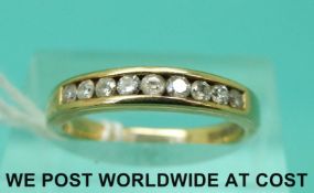 A 9ct gold ring set with nine diamonds in a row (size K/L)