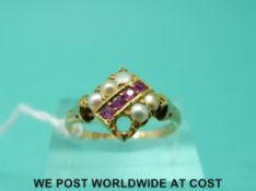 A 15ct gold ring set with a row of rubies and two rows of seed pearls (size Q)