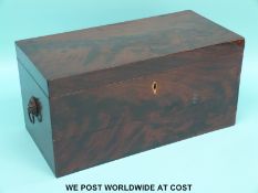 A Georgian flame mahogany tea caddy with lion mask handles,