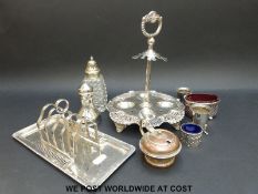 A white metal and cranberry glass salt marked sterling raised on bun feet together with a silver