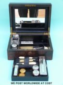 A brass mounted leather vanity box with contents, lift out tray, drop down mirror and Bramah lock,