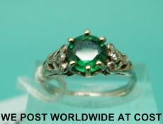 A white metal ring marked 18ct set with an emerald doublet with diamonds to the shoulders (size M)