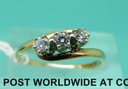 A 9ct gold ring set with three diamonds in a twist setting (size M)