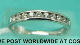 A platinum half eternity ring set with diamonds (size K/L)