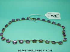 A yellow metal late Victorian / early Edwardian necklace set with 28 oval cut amethysts