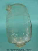 A glass bar top barrel drinks dispenser with graduations marked to side