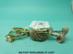 Two silver gilt rings set with diamonds in a twist setting,