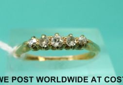 An 18ct gold ring set with five old cut diamonds (size M)