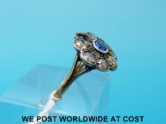 A Victorian 18ct gold ring set with a sapphire surrounded by diamonds (size K)