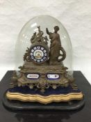 A late Victorian spelter and porcelain table clock, the 8 day movement striking on a bell,