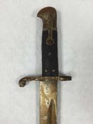 A British Model 1856 Sword Bayonet, 58cm recurving blade, steel mounted leather scabbard.
