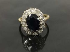 An 18ct gold sapphire and diamond cluster ring, size P.