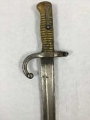 A French Chassepot Yataghan sword bayonet, 57cm recurving blade, in steel scabbard.