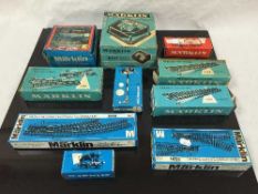 A quantity of Marklin model railway pieces including track, four carriages, signals, a transformer,