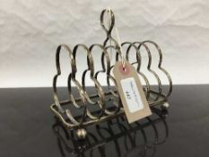 A silver seven bar toast rack, London 1903, 235g.