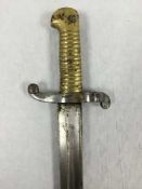 A French Chassepot Yataghan sword bayonet, 57cm recurving blade, in black painted steel scabbard.