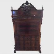 A nineteenth century mahogany secretaire, on ornate scroll feet, width 105 cm, with key.