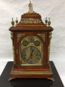 An impressive Victorian oak chiming double fusee bracket clock, the pediment with brass urn finials,