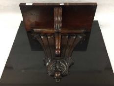 A mid nineteenth century mahogany wall bracket, the back carved with seven plumes ,