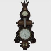 A carved oak combination wall clock/thermometer/barometer, circa 1900.
