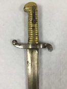 A French Chassepot Yataghan sword bayonet, 57cm recurving blade, black painted steel scabbard.