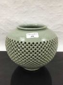 A Chinese Celadon type vase, with detailed banded reticulated walls,