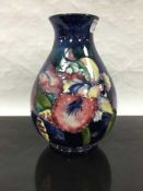 A Moorcroft orchid pattern bulbous vase, height 24cm.