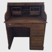 An early twentieth century oak roll topped desk, width 91 cm.