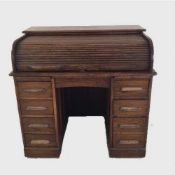 An Edwardian oak roll topped pedestal desk, width 106 cm.