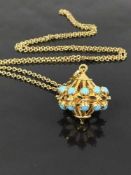 A yellow metal and turquoise pendant, the bale stamped .