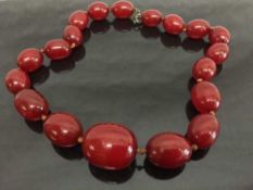An early twentieth century cherry amber necklace, 79.3g.