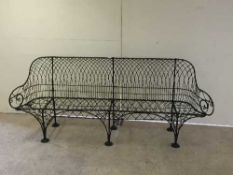 A Victorian wire-work garden bench, the all-wire design standing upon inverted leaf feet,