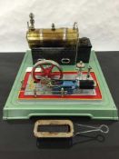 A Fleischmann steam stationary engine and single fixed cylinder motor, on tin base.