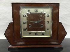 An Art Deco oak cased 8 day mantel clock, the square silvered dial with arabic numerals,