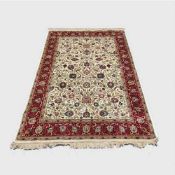 A silk finished Persian carpet on cream ground 154 cm x 226 cm.
