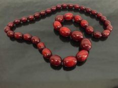 An early twentieth century cherry amber necklace, 120.2g.