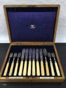 An oak cased canteen of silver cutlery, one fork associated, Sheffield 1909.